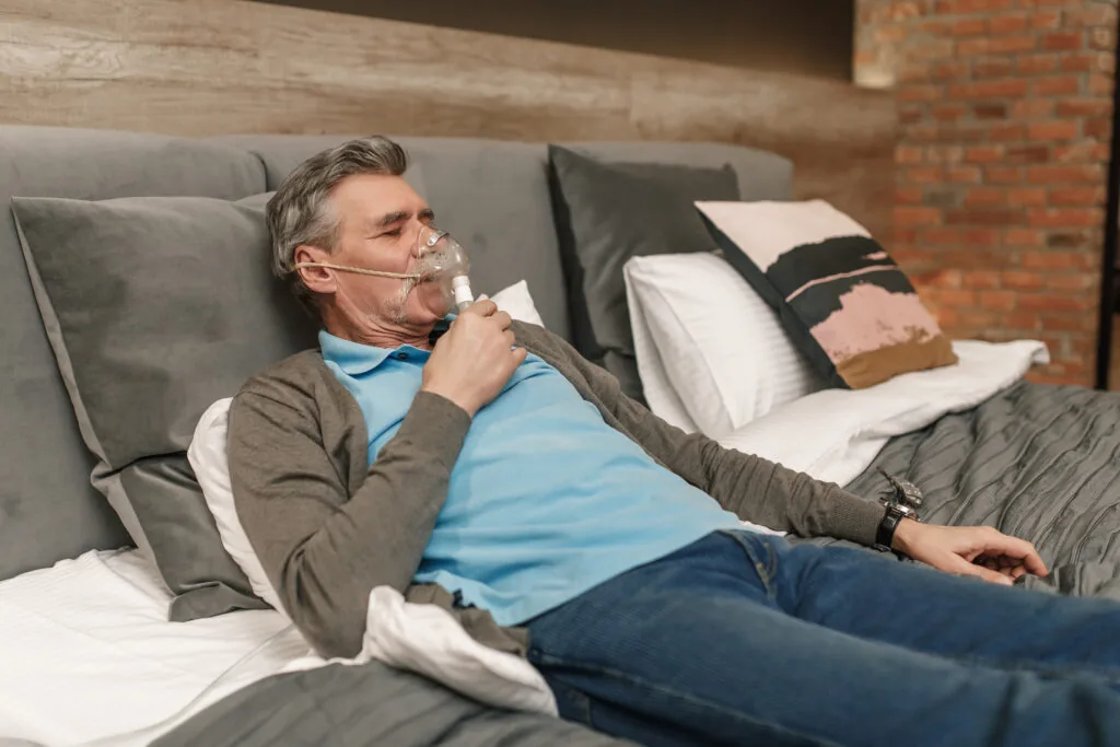 An older man sleeping soundly wearing a clean CPAP mask