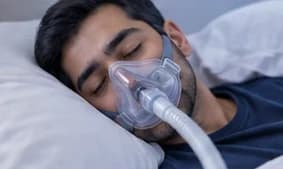 A person sleeping calmly while wearing a CPAP mask